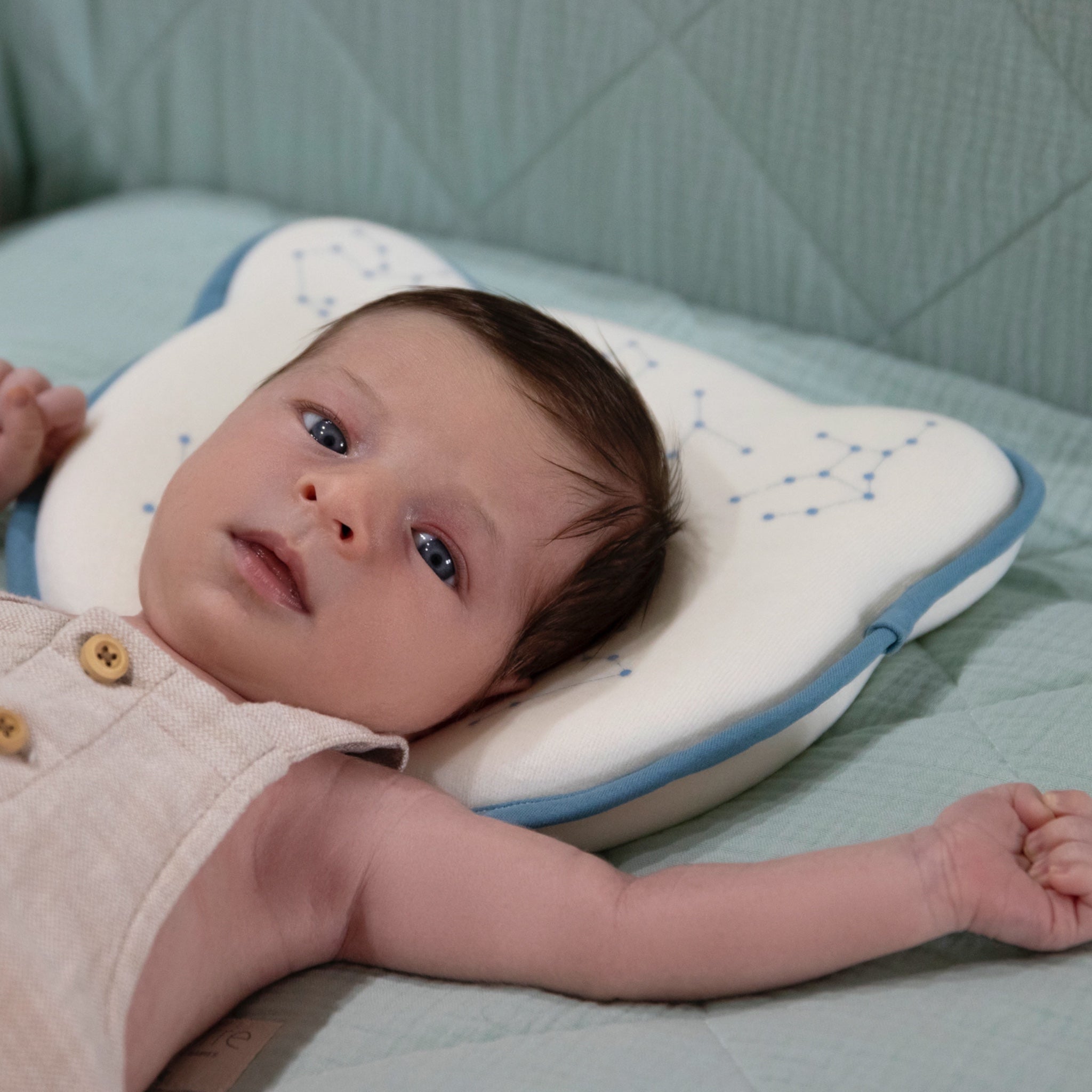 Baby using the Bear Cushion during a supervised moment